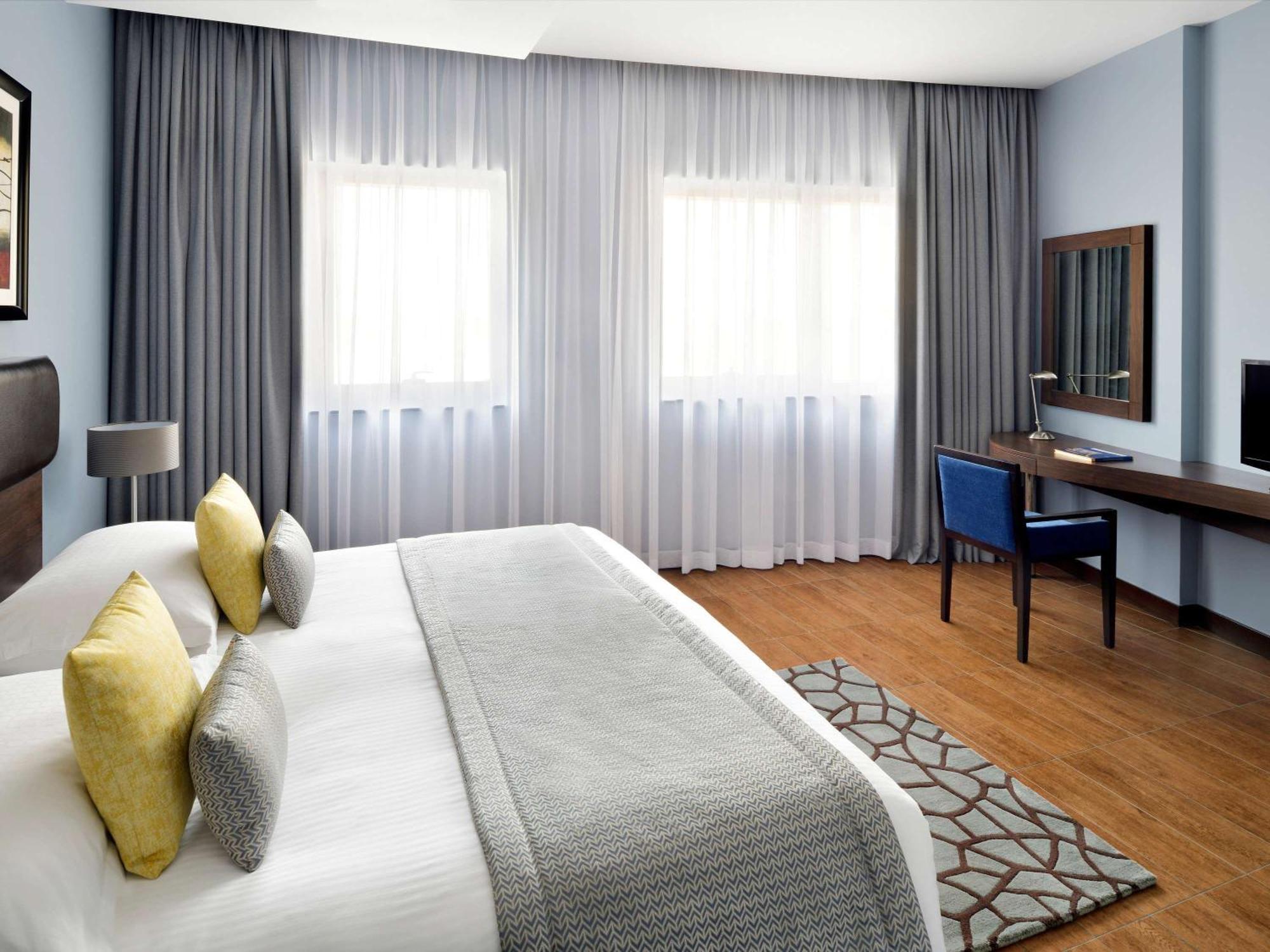 Moevenpick Hotel Apartments Al Mamzar Dubai Ngoại thất bức ảnh A bedroom at the hotel